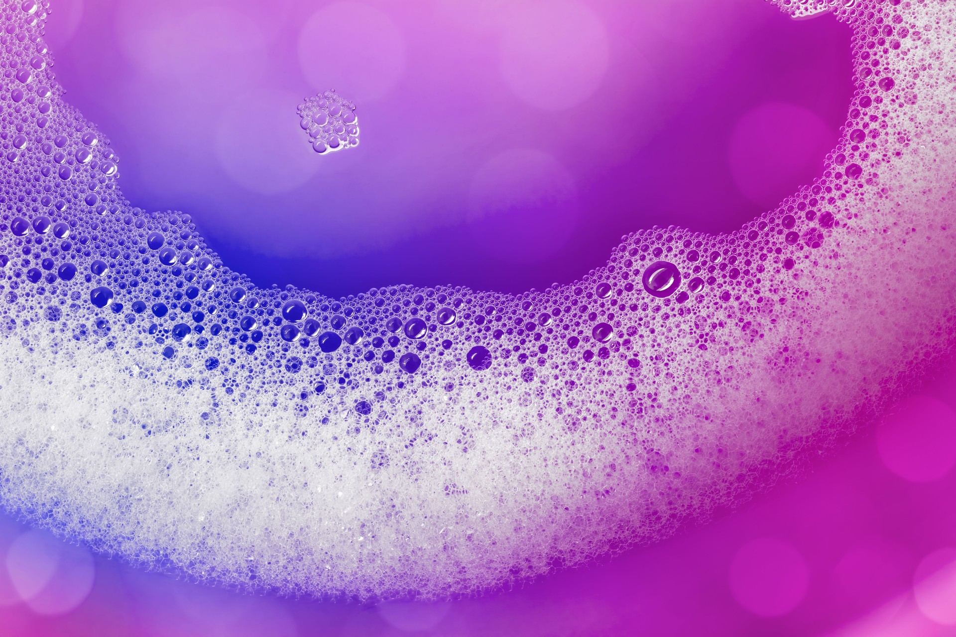 Soap suds background (purple) with copy space