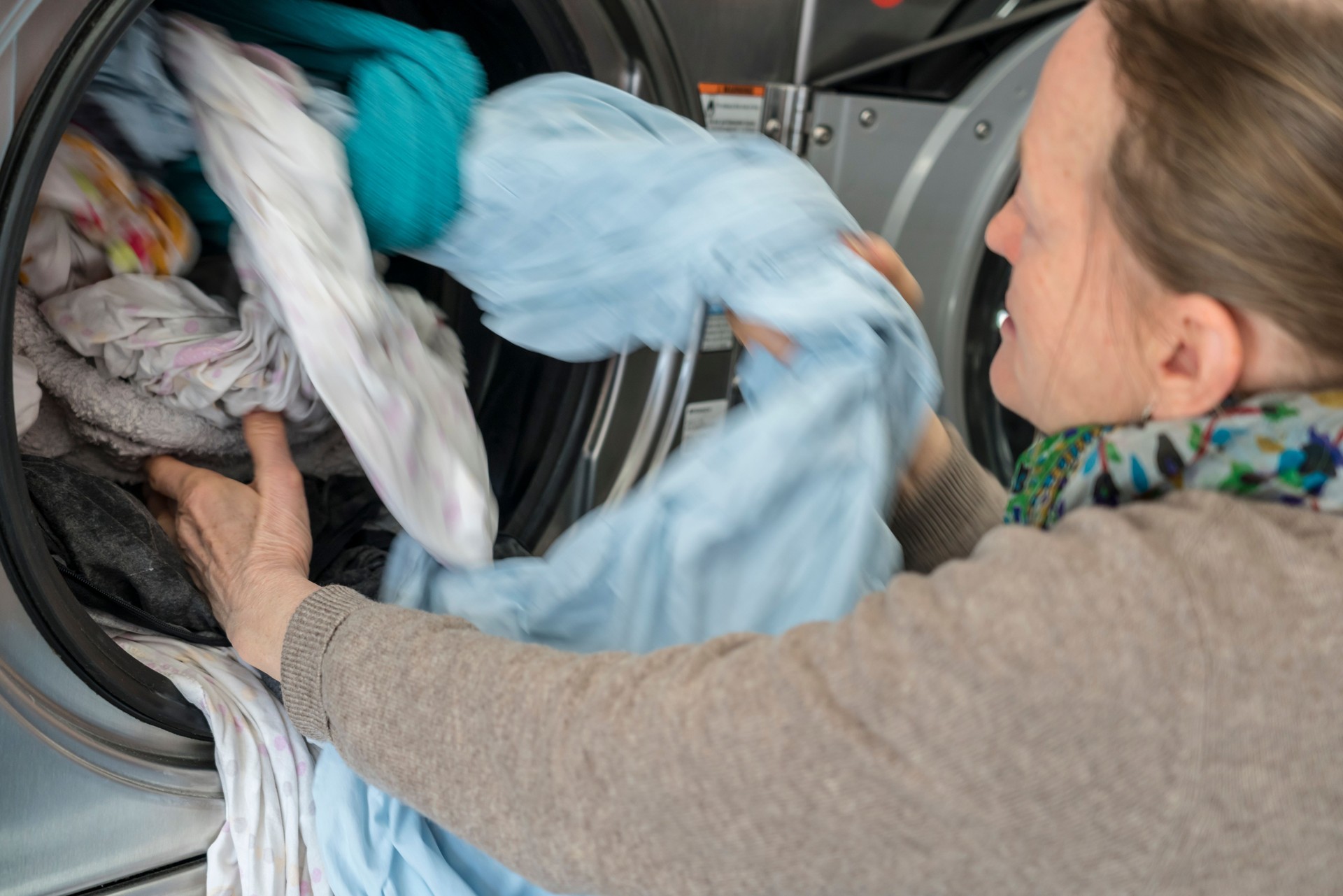 Women using washing machine at Public Laundromat Service